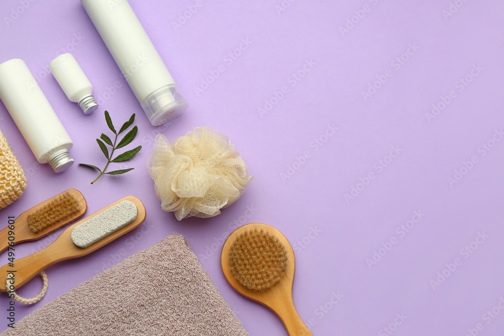 Set of bath supplies with cosmetic products on lilac background Set of bath supplies with cosmetic products on lilac background