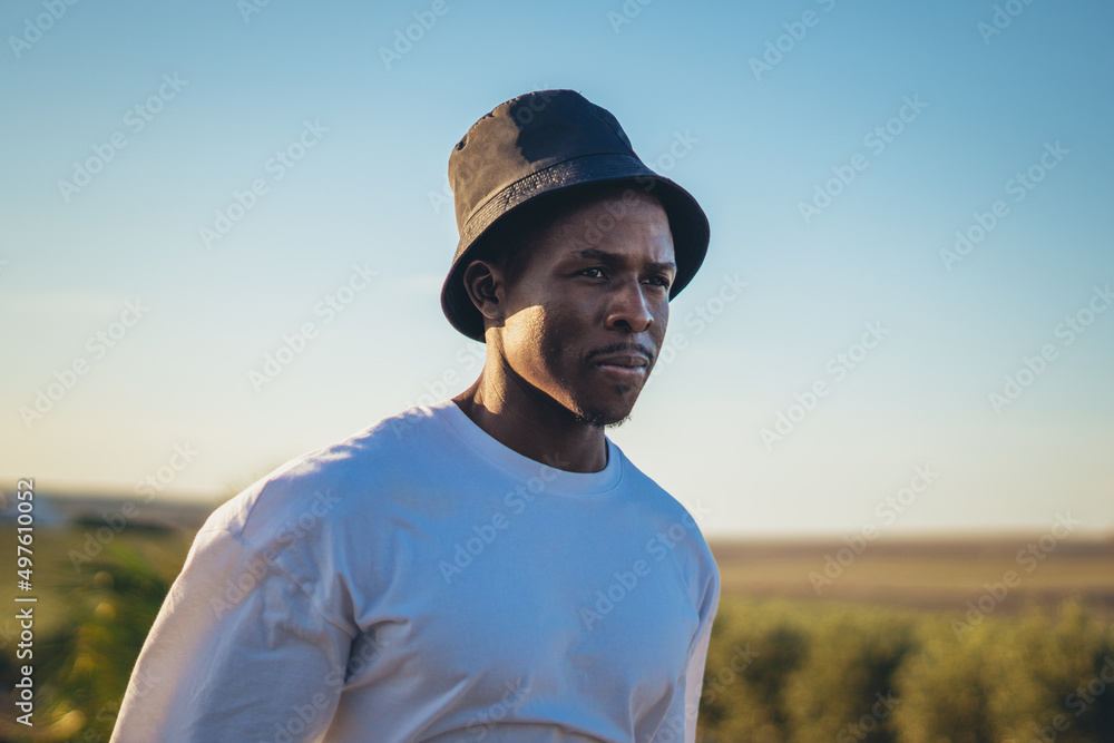 Portrait of a black man walking on a countryside road