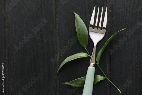 Modern silver fork with gre...