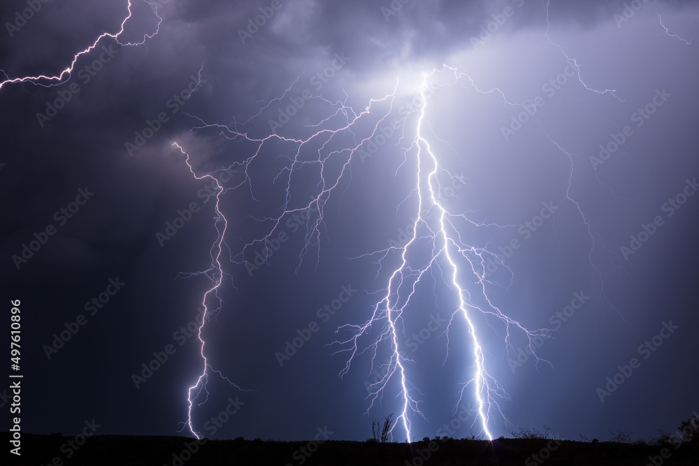 Dramatic lightning bolts strike in a thunderstorm Dramatic lightning bolts strike in a thunderstorm