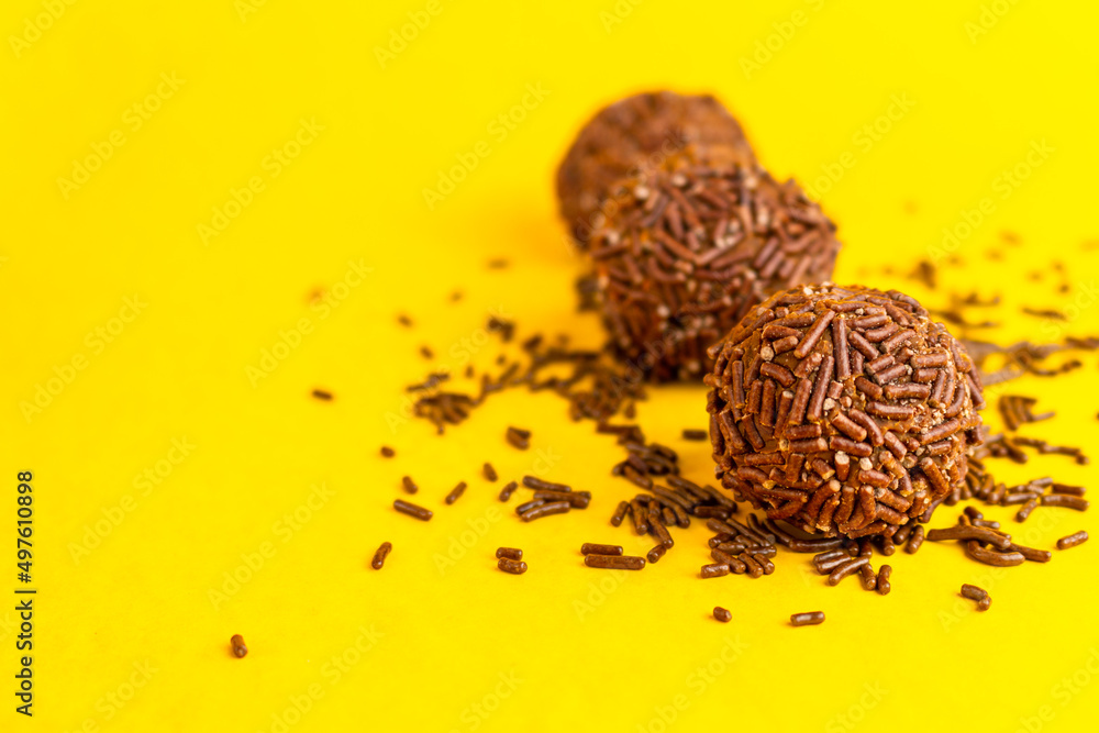 Brigadeiros lined up on a yellow background Brigadeiros lined up on a yellow background