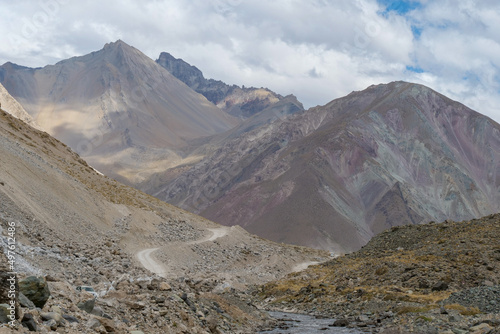 A gravel road leading through the Andes Mountain range en route to Valle de Colina, Chile, South America photo