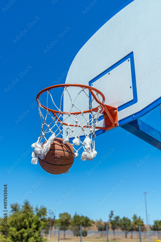 Sporty Caucasian male with tattoos playing basketball Sporty Caucasian male with tattoos playing basketball