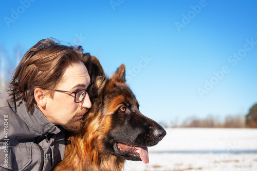 Portrait of a man with his German Shepherd dog. © наталья саксонова