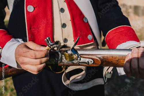 Soldier loading an old weapon. Napoleonic wars photo