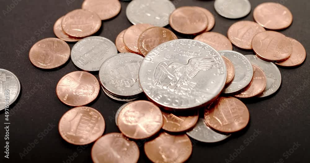Eisenhower Dollar on top of different US Dollar coins pennies dimes and quarters. Inflation in the United States of America Eisenhower Dollar on top of different US Dollar coins pennies dimes and quarters. Inflation in the United States of America