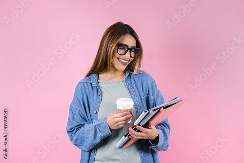 young hispanic business woman smiling at camera on pink background in Mexico Latin America 