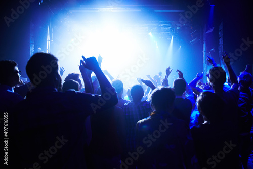 This concert is next level. A crowd of people cheering the band on st. © Jeff B/peopleimages.com