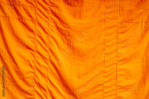 Full frame close up of an orange piece of fabric (cowl)