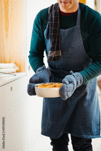 Anonymous man holding fresh baked food