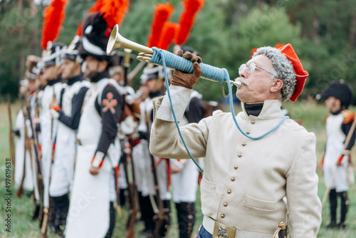  White mature male soldier plays the trumpet.