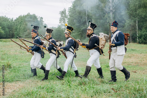 Army soldiers with weapons on the battlefield. 