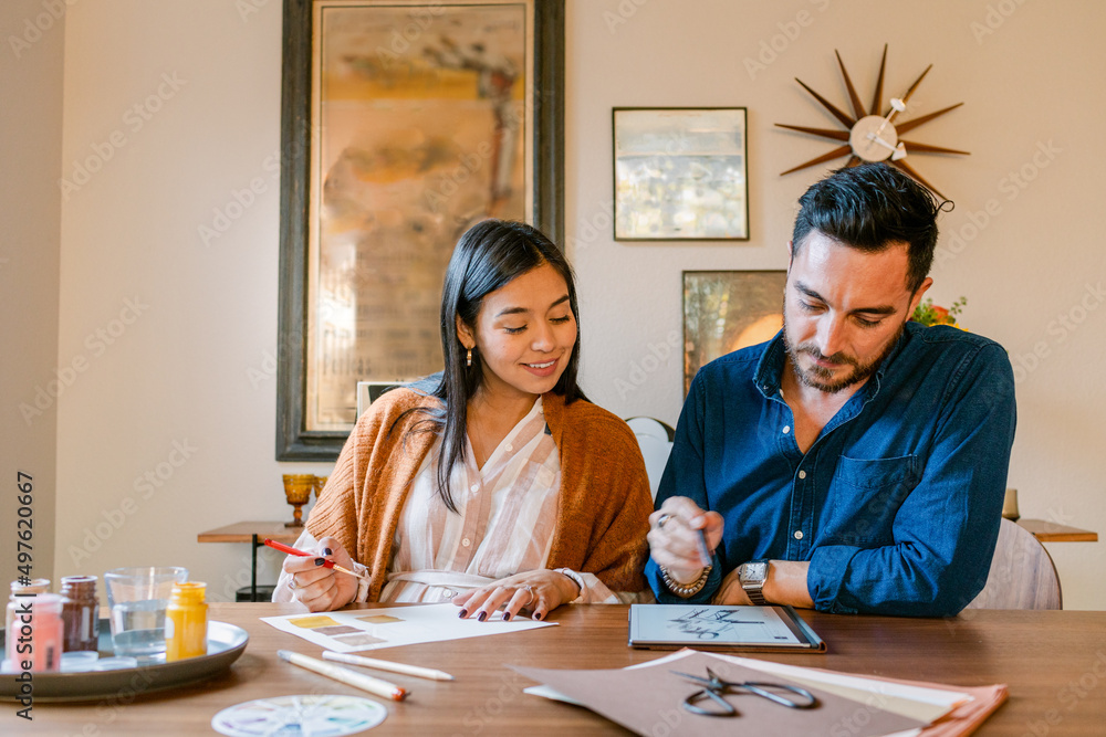 Designers couple drawing sketches at home Designers couple drawing sketches at home