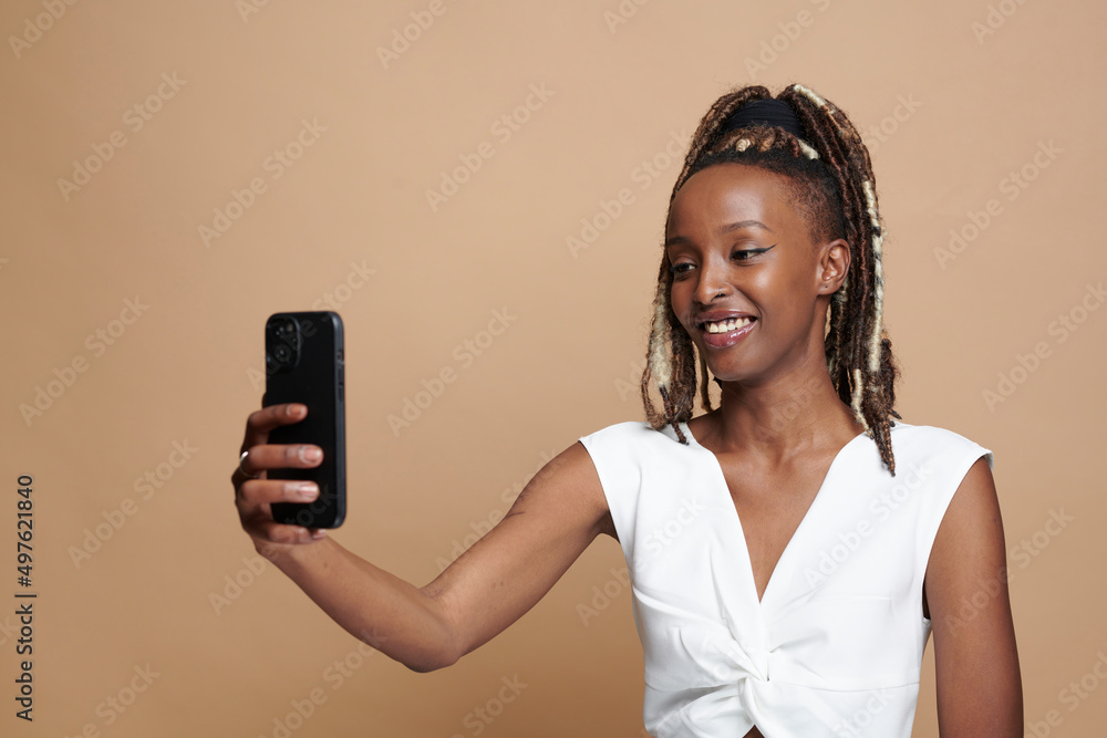 Beautiful black woman smiling wearing white dress and rasta laughing Beautiful black woman smiling wearing white dress and rasta laughing