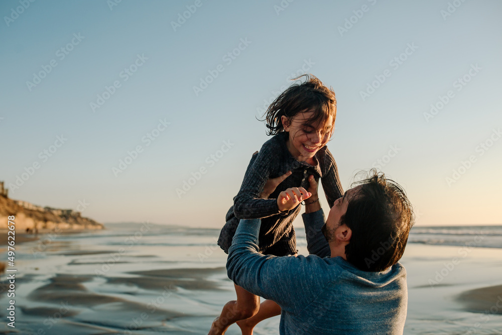 Father lifting daughter into the air Father lifting daughter into the air