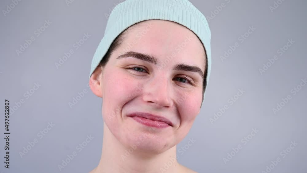 Close-up portrait of a young woman massaging her face with a gouache scraper. Close-up portrait of a young woman massaging her face with a gouache scraper.