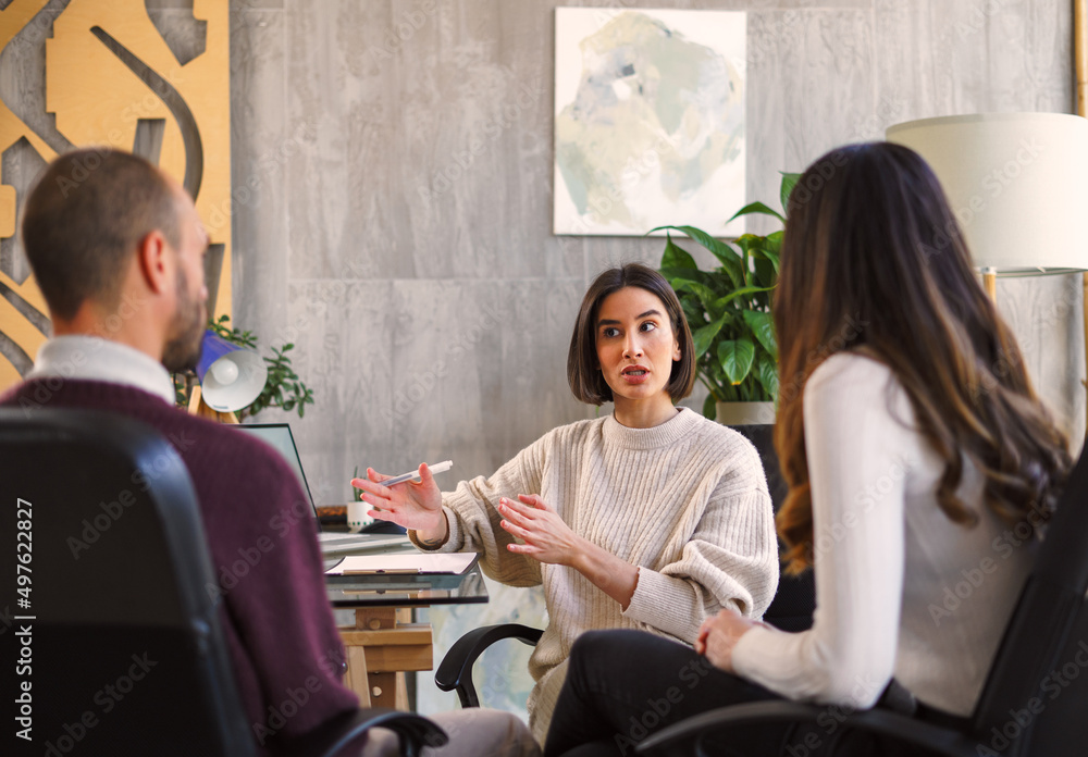 Focused psychologist communicating with patients Focused psychologist communicating with patients
