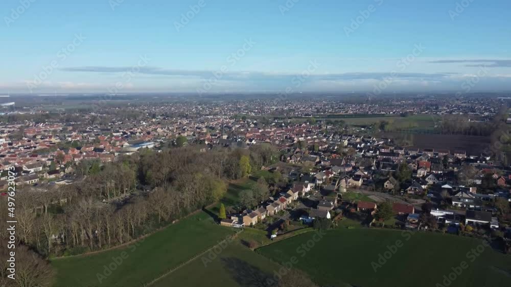 Aerial view village Sprundel in Netherlands with windmill Molenerf and clear blue skies and church Aerial view village Sprundel in Netherlands with windmill Molenerf and clear blue skies and church