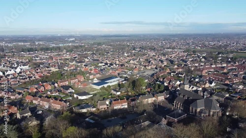 Aerial view village Sprundel in Netherlands with clear blue skies and churches and Rucphen at the horizon photo