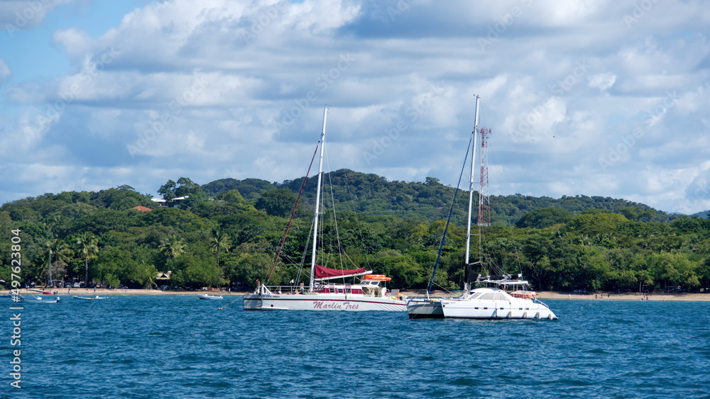 Sailboats moored in the bay, off the beach in Tamarindo, Guanacaste, Costa Rica