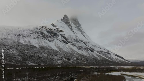 Majestic Snowy View Of The Otertinden Mountain In Signaldalen, Norway - panning wide shot photo