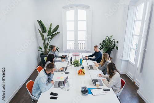 Group of colleagues discussing project in boardroom photo