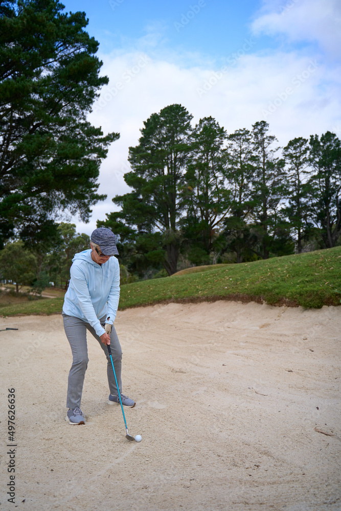 Golfer in sand bunker using sand wedge iron Stock Photo Adobe Stock