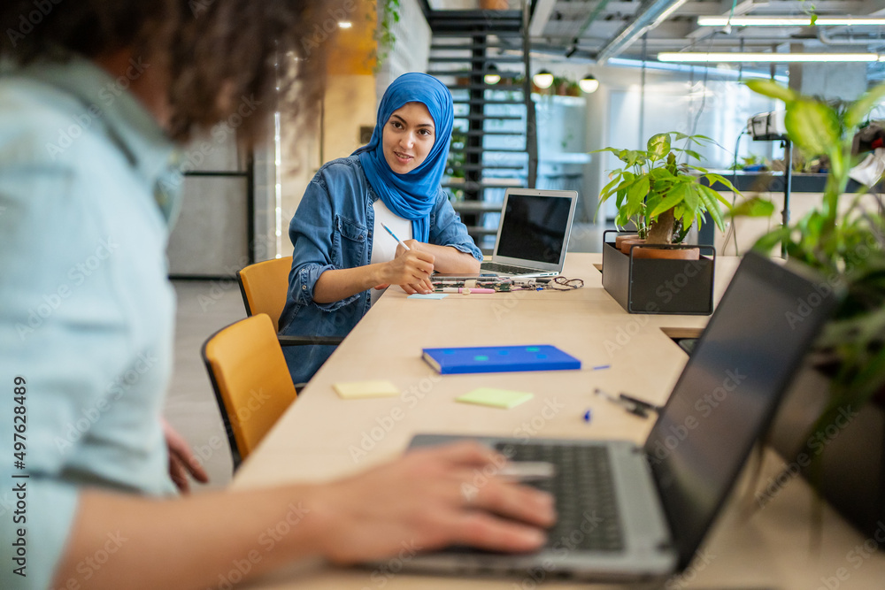 Muslim Woman In A Modern Co-Working Office. Muslim Woman In A Modern Co-Working Office.