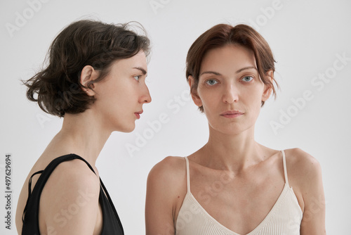 Young woman opposing androgynous girlfriend photo