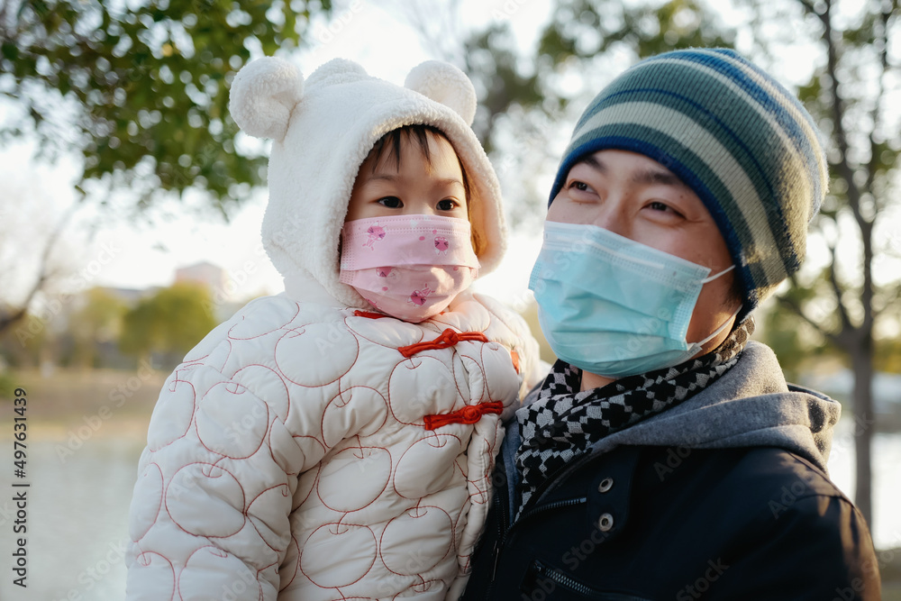 Asian baby in annual clothes with dad in the park Asian baby in annual clothes with dad in the park