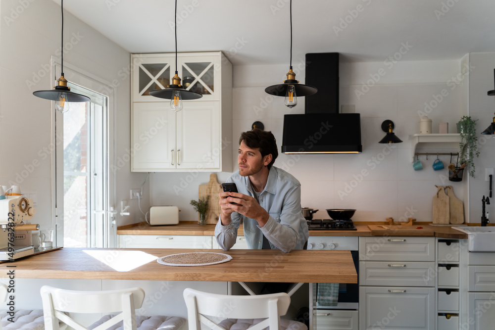 Portrait of happy confident man with phone at home Portrait of happy confident man with phone at home