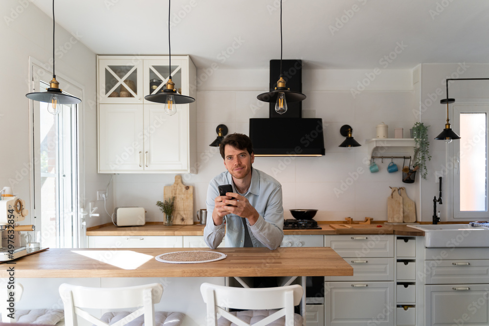 Portrait of confident man with phone at home Portrait of confident man with phone at home