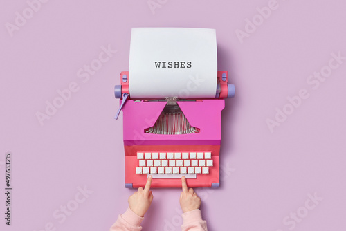 Kid using retro typewriter for writing letter photo