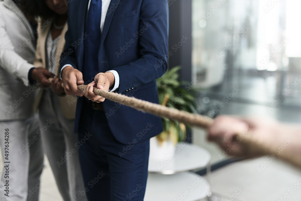 Teamwork can defeat any challenge. Closeup shot of a group of unrecognizable businesspeople pulling together on a rope in an office. - obrazy, fototapety, plakaty 