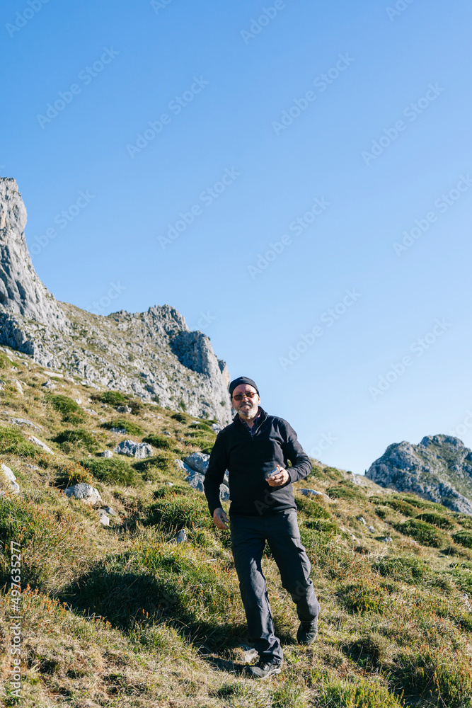 Man standing on mountain slope Man standing on mountain slope