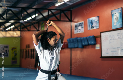 Man training martial arts with katana