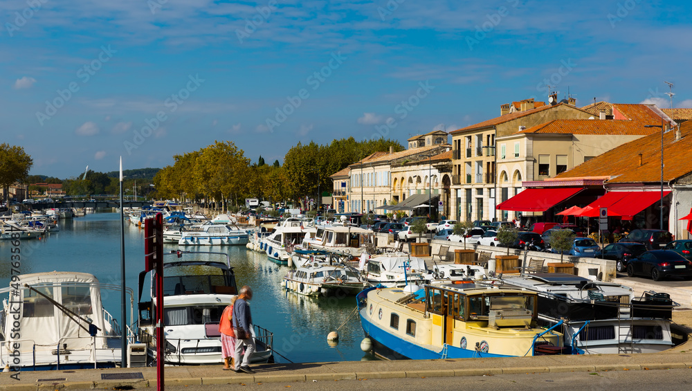 View of bay with boats and old houses of Beaucaire, France