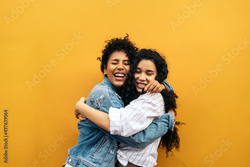 Happy young women hugging photo