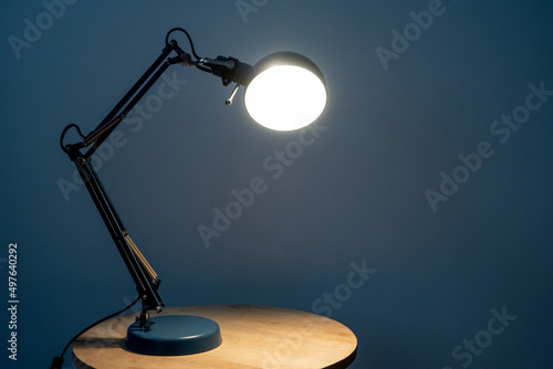 Vintage desk lamp on wooden table photo