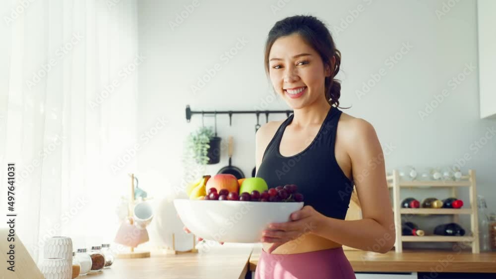 Portrait of Asian attractive woman hold fruit bowl and look at camera. Portrait of Asian attractive woman hold fruit bowl and look at camera.