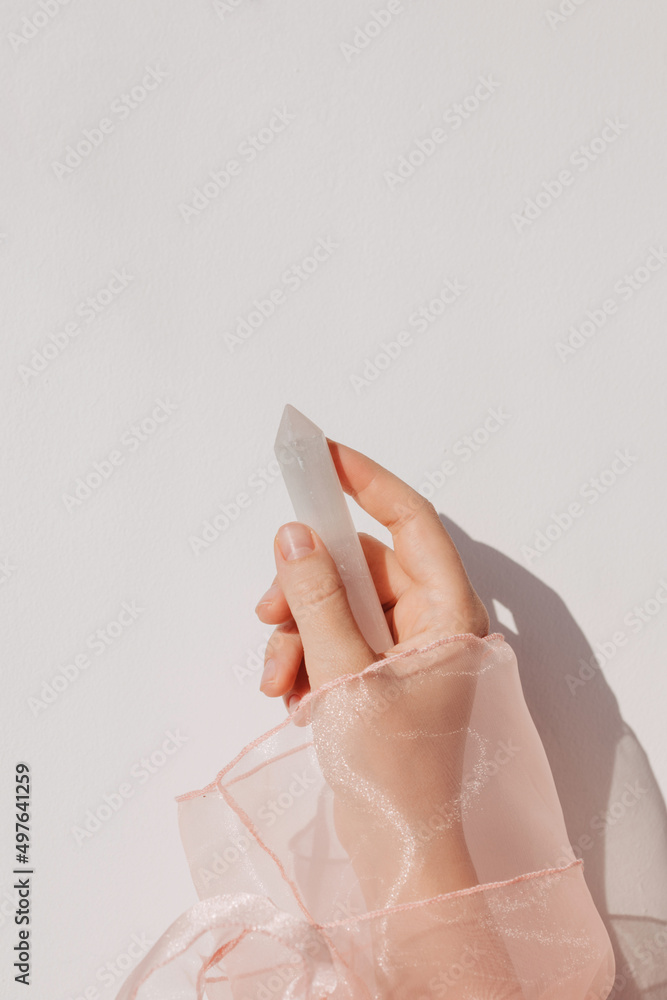 Hand with selenite crystal Hand with selenite crystal