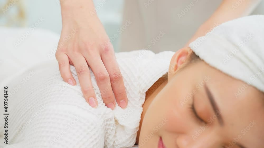 Asian young happy woman feeling relax during shoulder and back massage Asian young happy woman feeling relax during shoulder and back massage