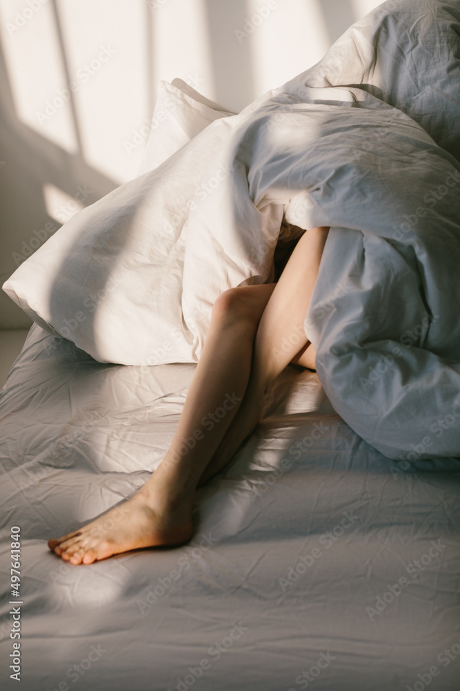 Barefoot Woman On Bed under blanket Barefoot Woman On Bed under blanket