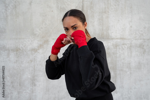 Serious sportswoman in fighting stance during workout