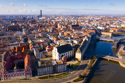 Picturesque aerial view of Wroclaw on Oder River bank overlooking historical Market Square with Old Town Hall, massive Gothic church of St. Elizabeth and St. Mary Magdalene Church in spring, Poland