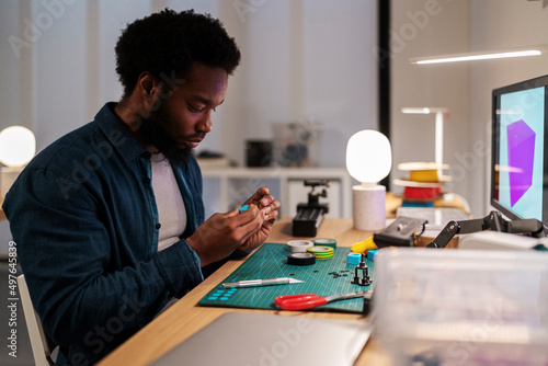 Serious designer forming 3D model at desk photo