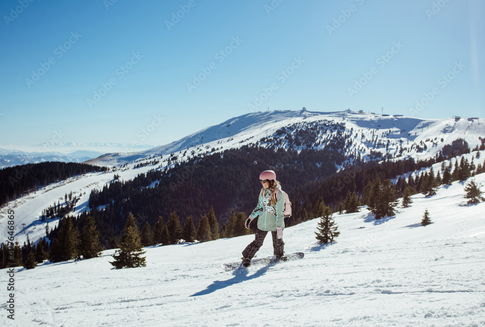 Smiling woman snowboarding Smiling woman snowboarding