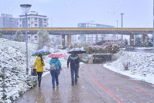 Pamplona, Navarra Spain april 01 2022, Surprise snowfall in early spring, people on the way to school Marists
