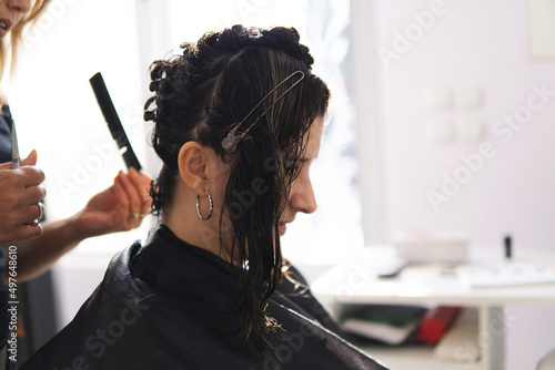Female hairdresser cutting woman's hair in beauty salon. © Dusan