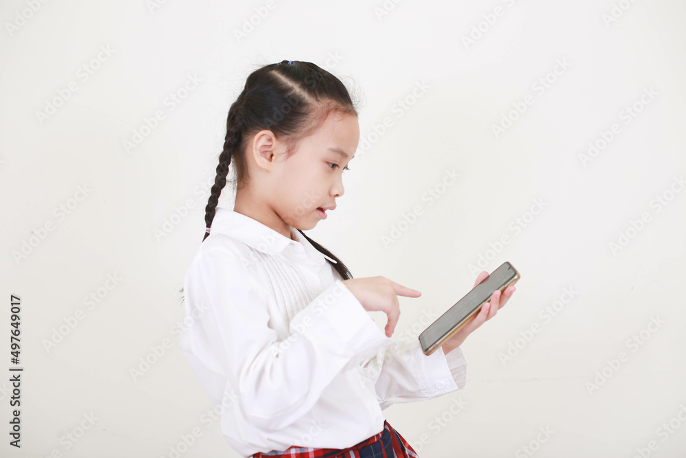 Smiling little girl lying on comfortable couch, enjoying playing online game on digital tablet computer. Addicted to technology, happy small kid using funny applications, web surfing information. Smiling little girl lying on comfortable couch, enjoying playing online game on digital tablet computer. Addicted to technology, happy small kid using funny applications, web surfing information.